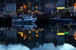 Christmas lights reflecting in Padstows inner harbour