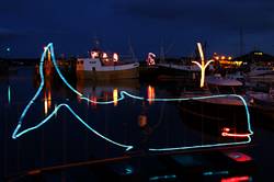 Christmas lights reflecting in Padstows inner harbour