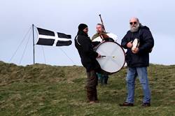 A piper and two drummers